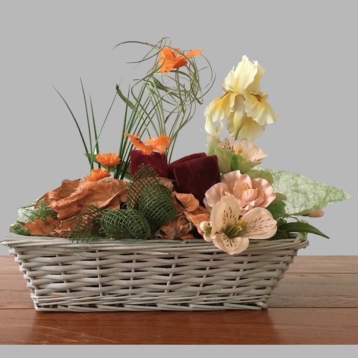 Flower arrangement with iris and butterflies in a square basket